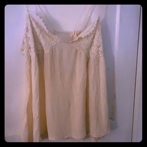 Cream colored tank top w/ tie.